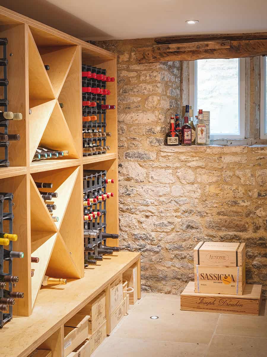 The Mount wine cellar with bespoke timber racking and exposed stone walls, Cotswolds cottage